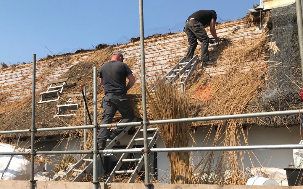Installing fire barriers for a thatched roof
